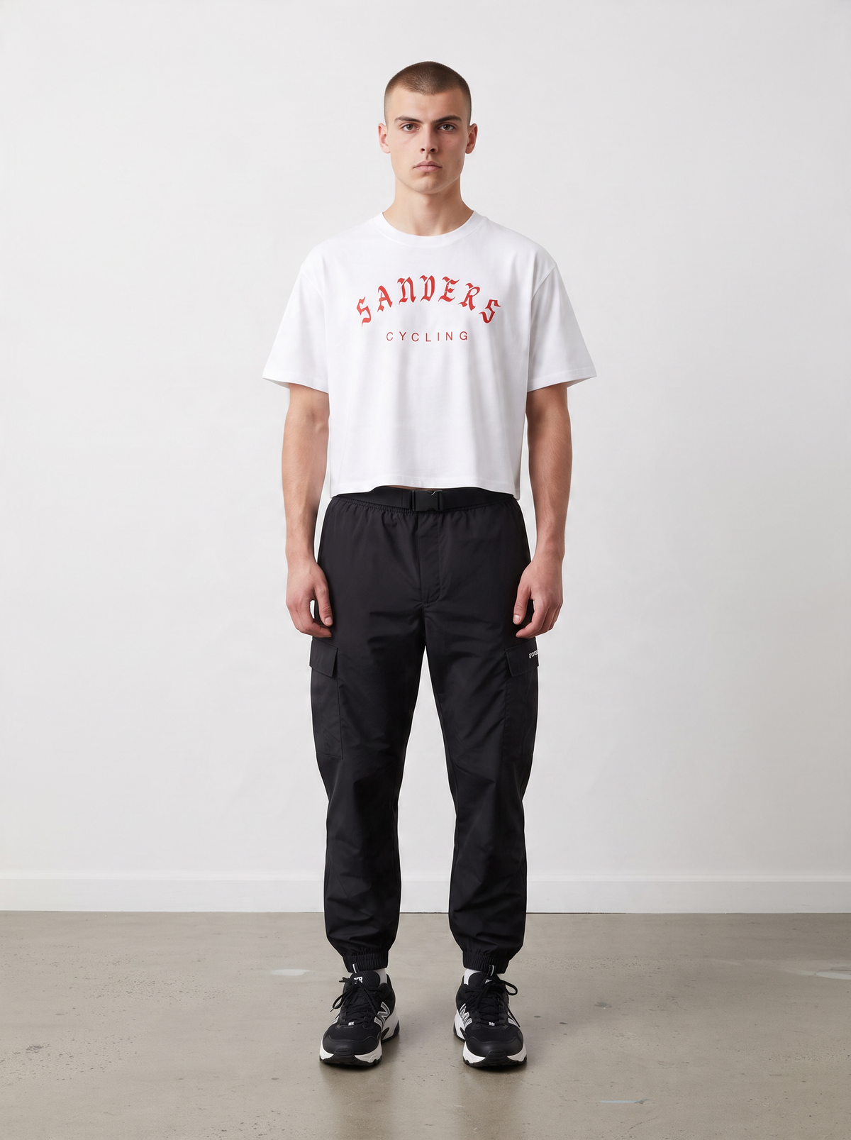SANDERS Cycling white boxy graphic tee with red print, worn with black cargo pants