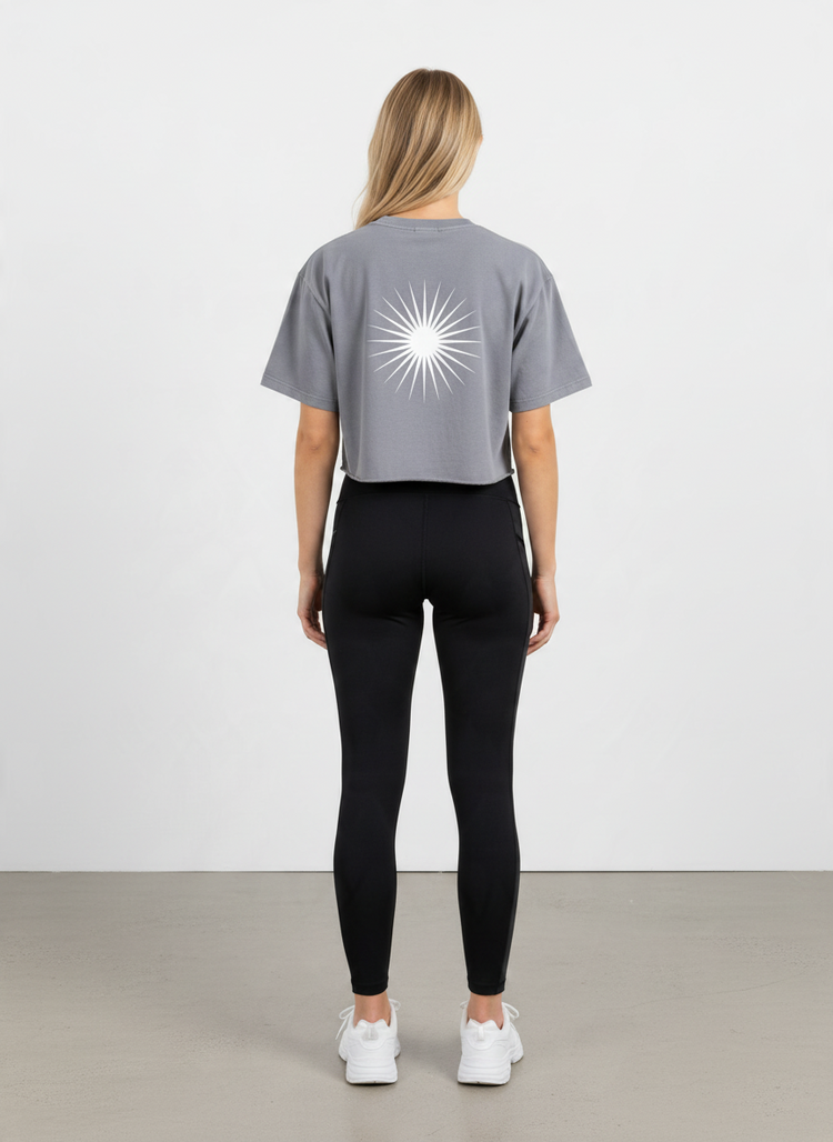 SANDERS Cycling washed gray crop top with white sunburst graphic on the back, worn by a model